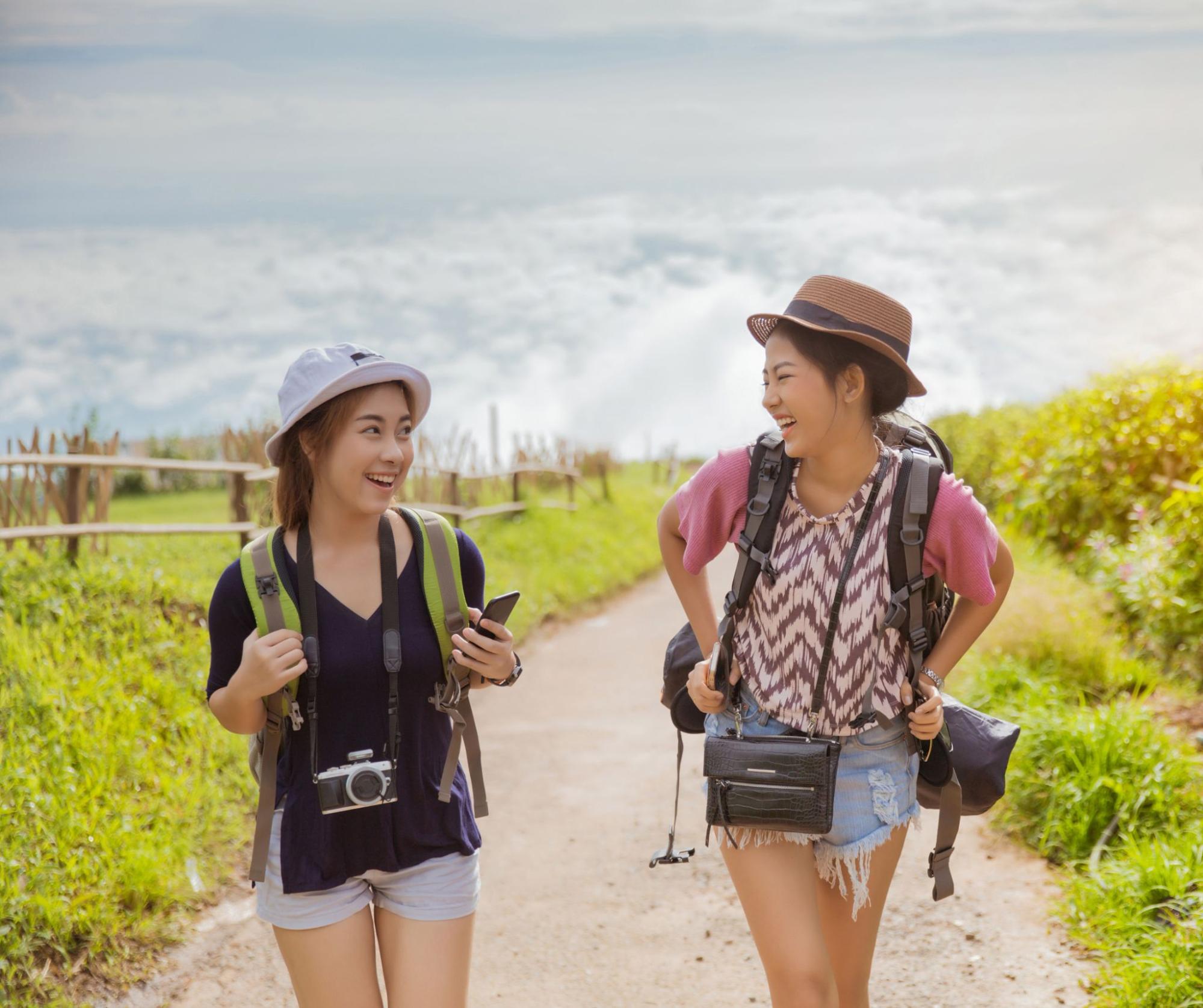 Two traveller women walking on a path.