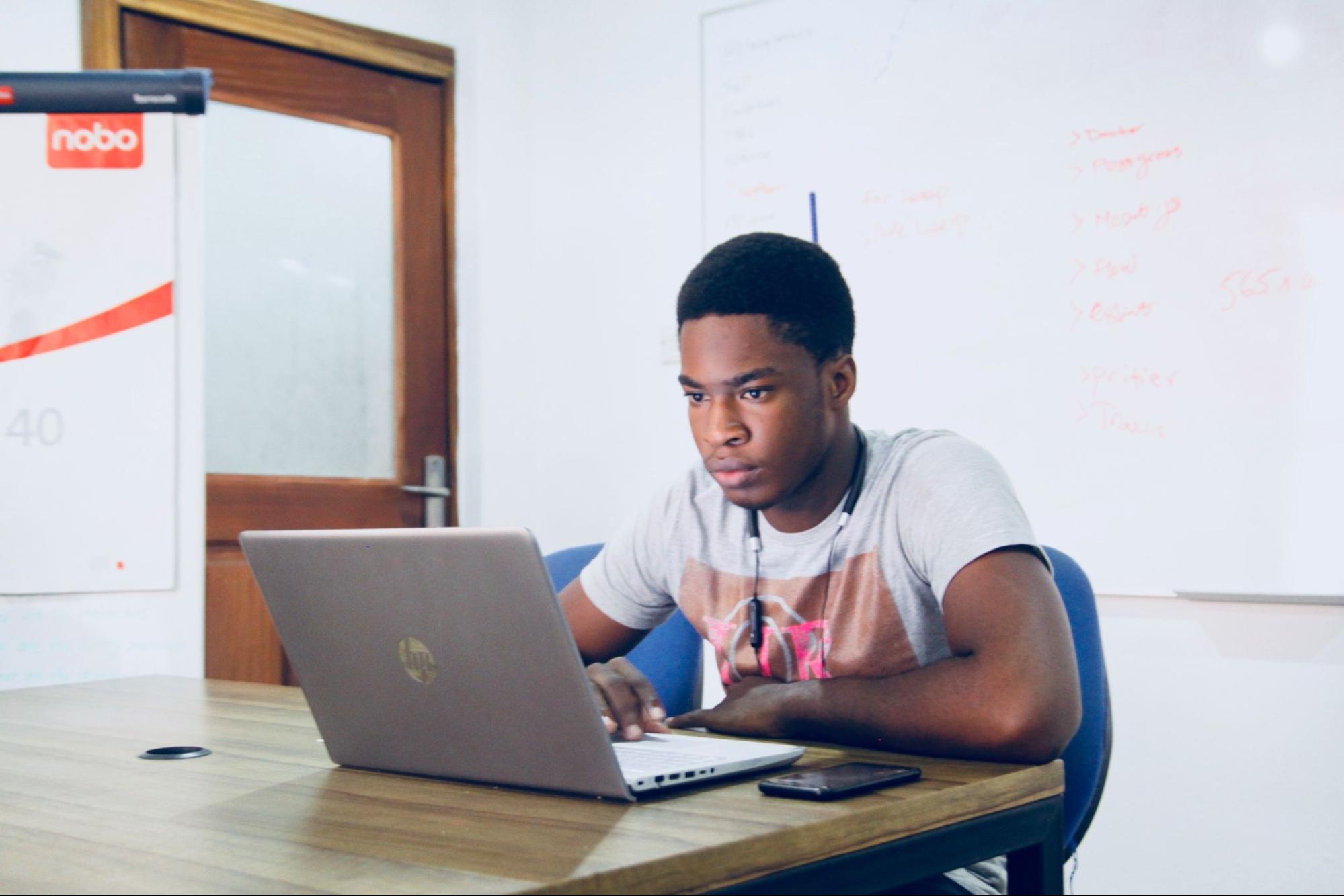 A student sitting at a desk with a laptop.